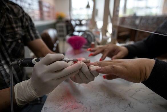 a person using a nail file for proper nail care