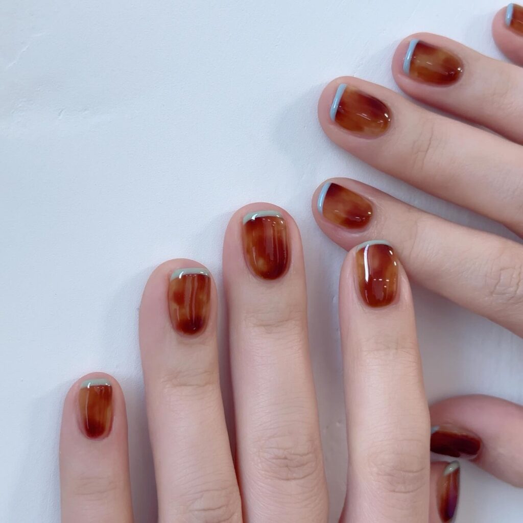 Mocha Mousse cloud marbling cute nail designs 2026 with French-inspired tips