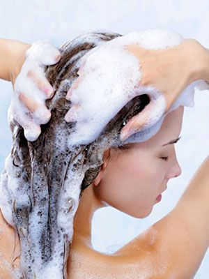 Gently massaging the scalp while wearing press-on nails