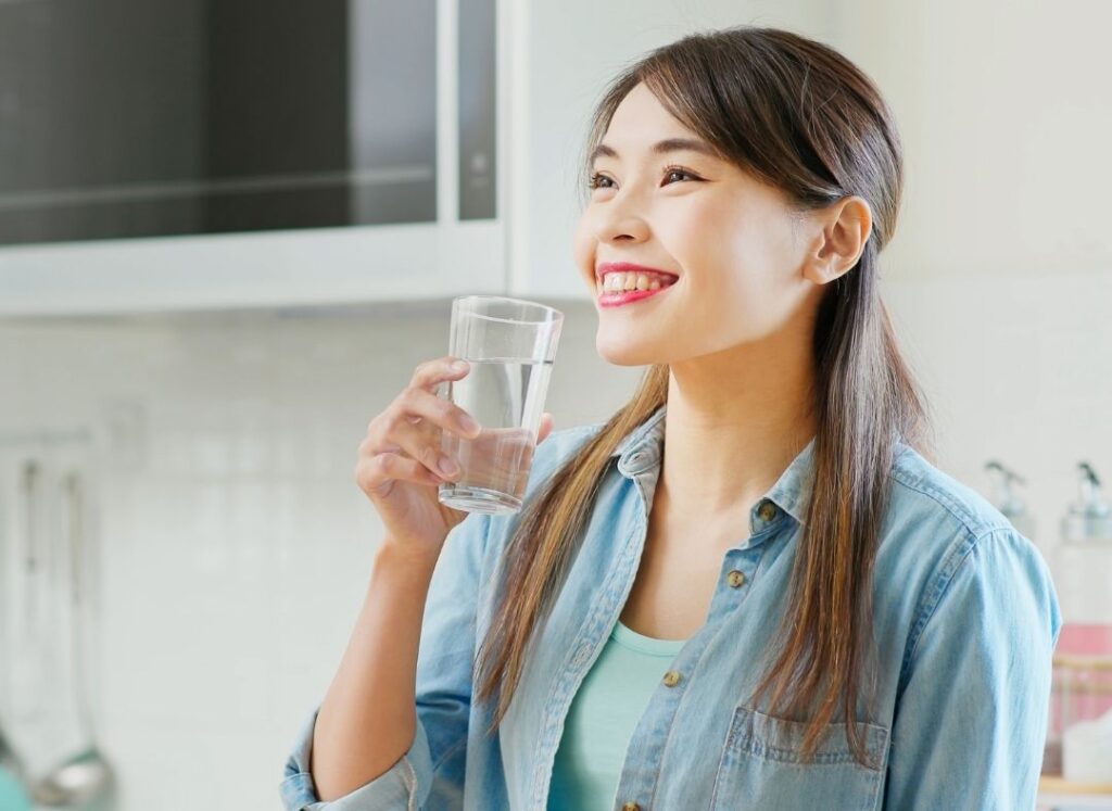 Staying hydrated supports how to grow nails faster and stronger by reducing brittleness
