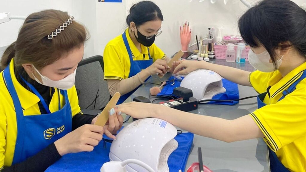 Nail students practicing at the academy