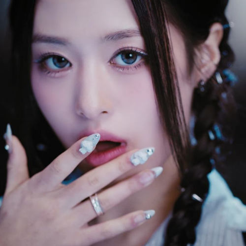 K-pop inspired nail designs with milky white ombré and subtle raised crystal accents inspired by Ahyeon (BABYMONSTER)